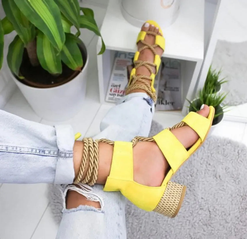 Women's beige suede sandals with front strap, thick middle heel, and ankle strap.