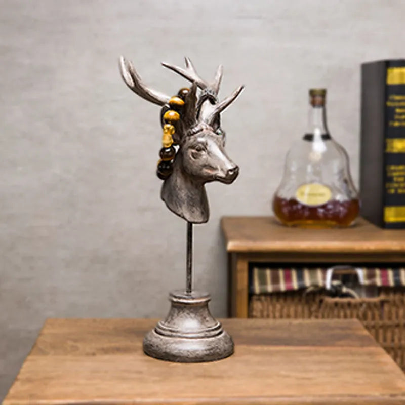 A tall black animal-shaped decorative ornament made from natural resin on a wooden shelf.