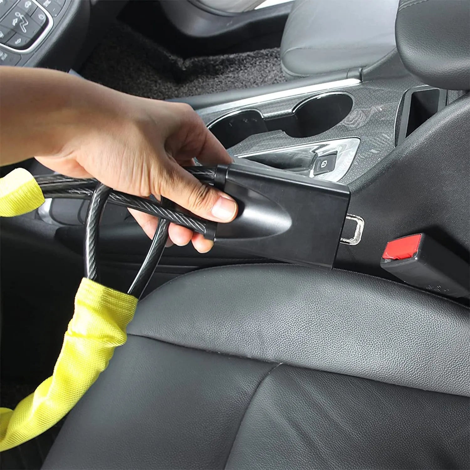 Red iron wire rope steering wheel lock for General Motors cars on a steering wheel.