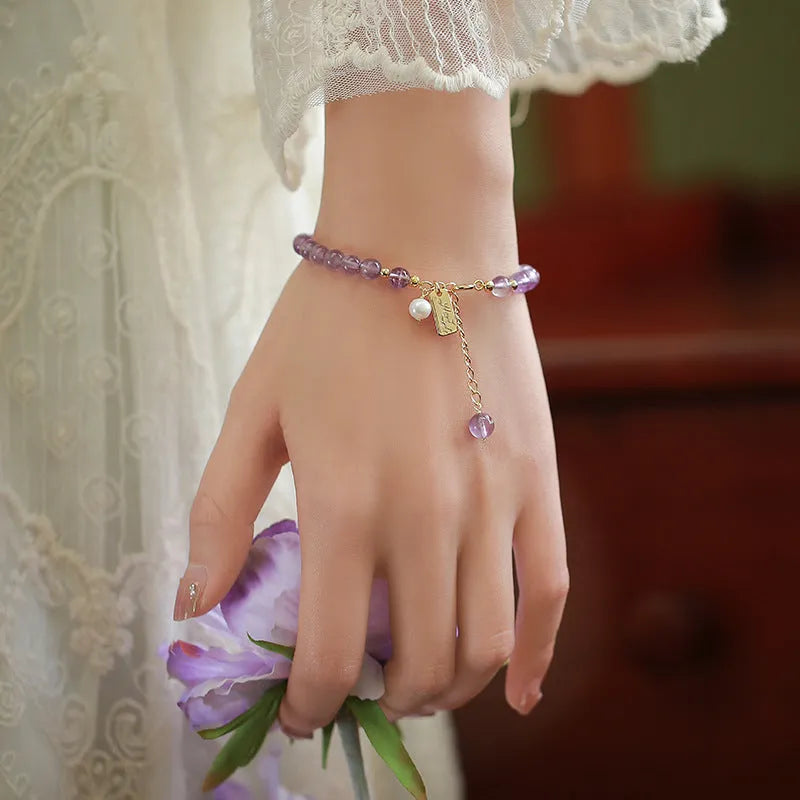 Women's natural crystal bracelet with lavender amethyst stones and animal zodiac design