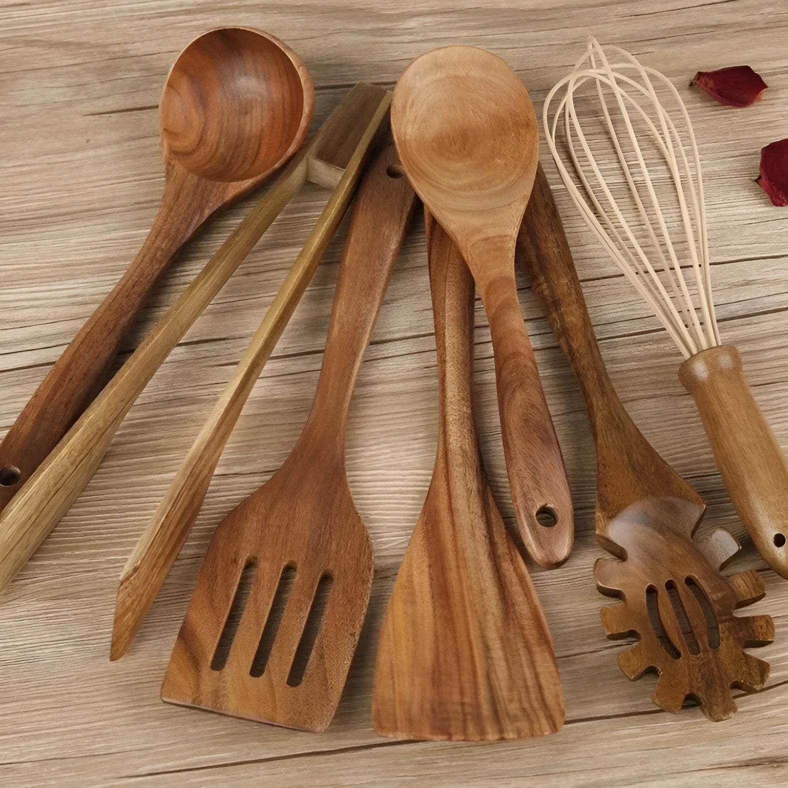 Seven wooden cooking utensils including spoons and spatulas arranged together