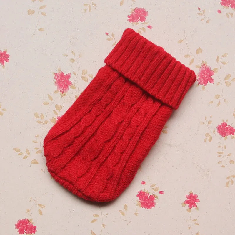 Knitted wool dog sweater with fabric buttons on a white background, shown in blue