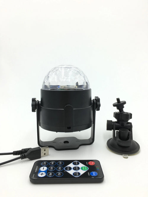 3W RGB LED crystal magic ball party light with remote control on a dark stage showing colourful light beams