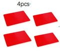 Red silicone pyramid grid cooking mat on a kitchen countertop.