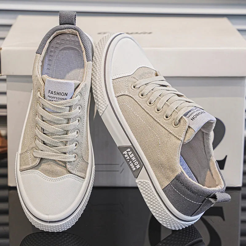 Men's blue low-top canvas skateboard shoes with round toe and white lace-up front.
