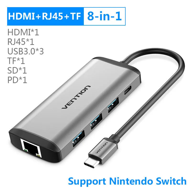 Deep grey USB-C to HDMI, USB 3.0, Ethernet and PD charging hub adapter on a desk