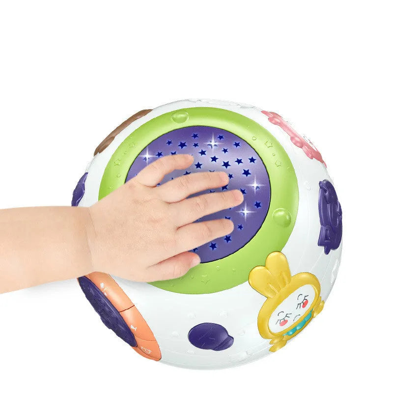 White plastic starry sky night light projector for children on a table, projecting blue stars onto a wall.