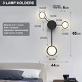 Contracted designer wall lamp with 6 heads in black iron and acrylic mounted on a bedroom wall