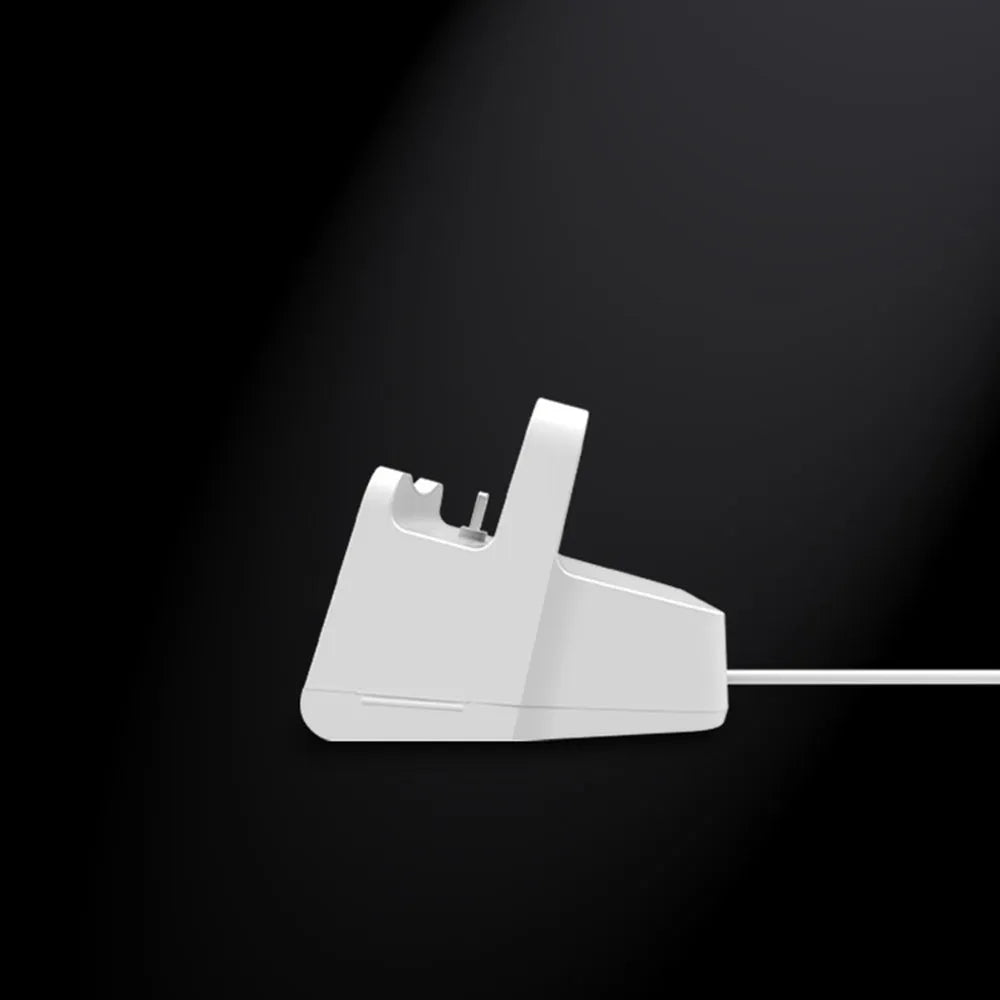White minimalist headphone charging base on a desk or table