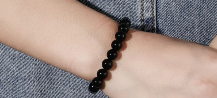 Black onyx bracelet with 8mm geometric beads on a stretchy elastic cord.