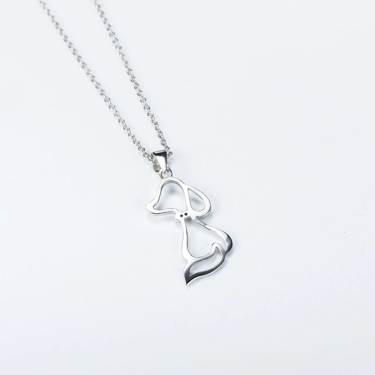 Ladies 925 sterling silver dog pendant necklace with adjustable round bead chain on neutral background
