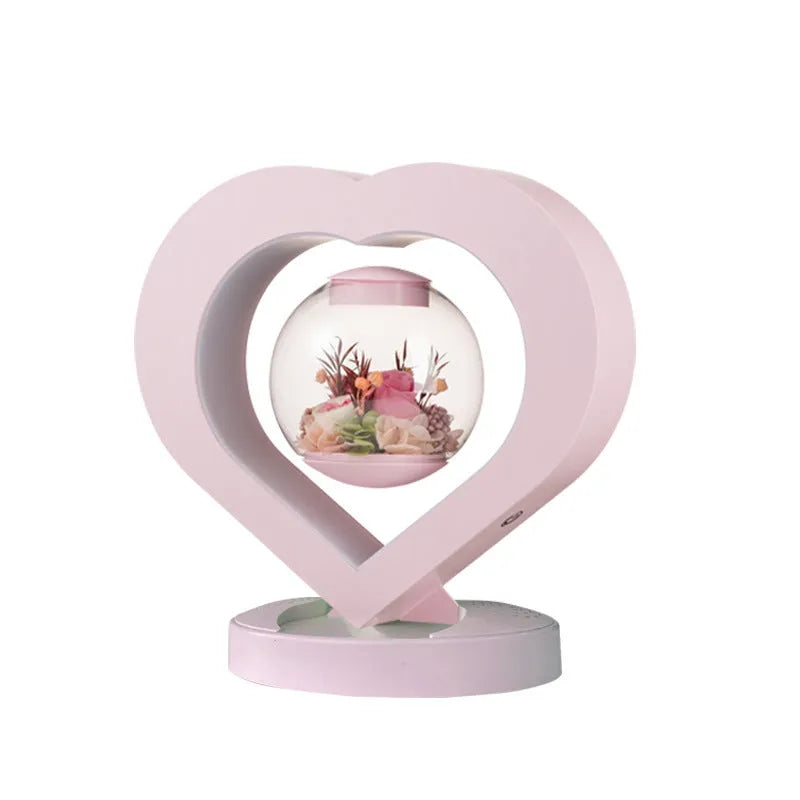 Pink preserved rose ornament in a decorative style, shown with optional base and bluetooth speaker features.
