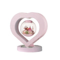 Pink preserved rose ornament in a decorative style, shown with optional base and bluetooth speaker features.