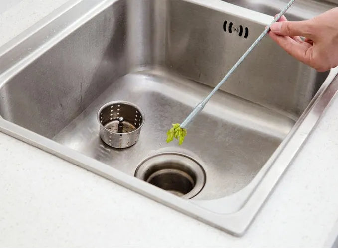 Flexible drain cleaning spring tool with gripped handle for removing hair from pipes