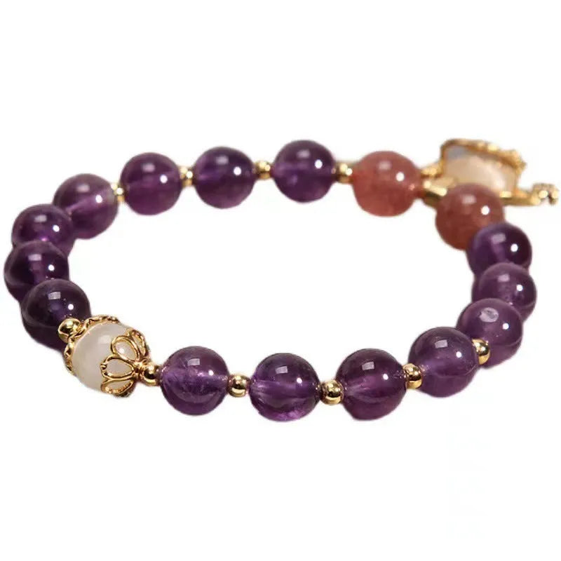 Women's copper bracelet with natural amethyst stones, gold accents, and a longevity lock charm