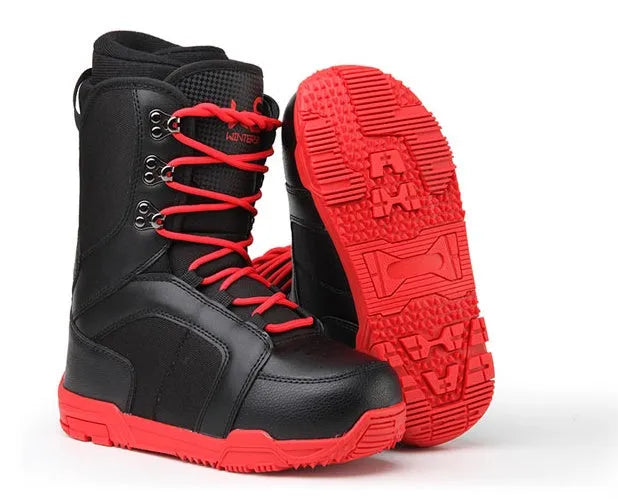 Black men's ski boots with tie closure and rubber outsole on a snowy surface