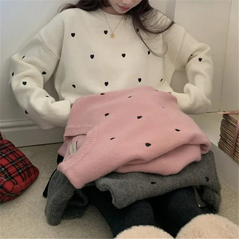 Women's loose grey acrylic pullover sweater with embroidery on the chest.