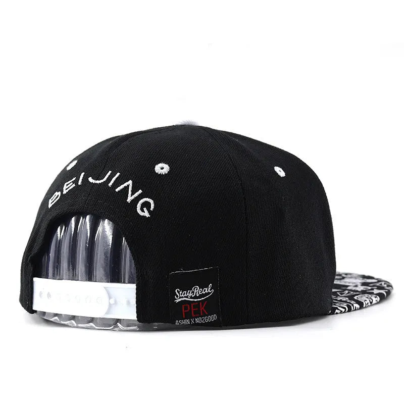 White cotton baseball cap with embroidered lettering on the front, showing the adjustable strap at the back.