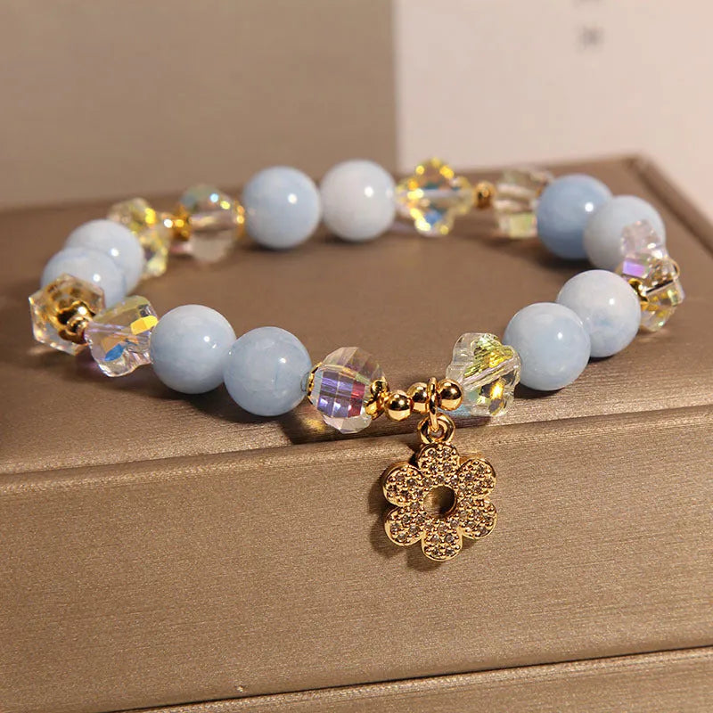 Women's aquamarine crystal bracelet with four-leaf clover charm and pearl decorative accents