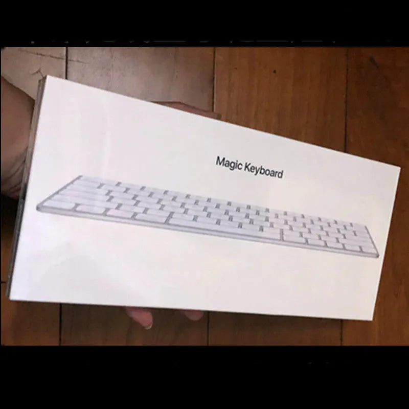 White Apple Bluetooth wireless keyboard with ultra-thin metal casing on a desk