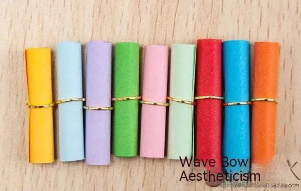 Colourful miniature paper scrolls for drift bottle messages with central eyelet for string attachment
