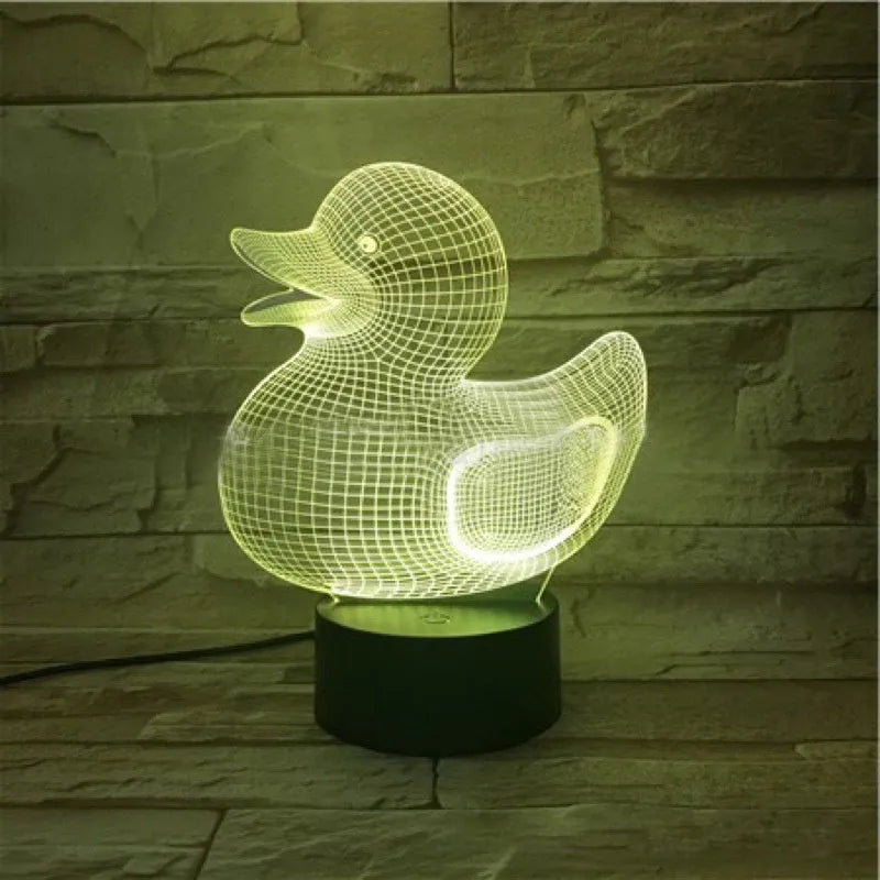 Little Yellow Duck shaped 3D acrylic night light with remote control on a table.