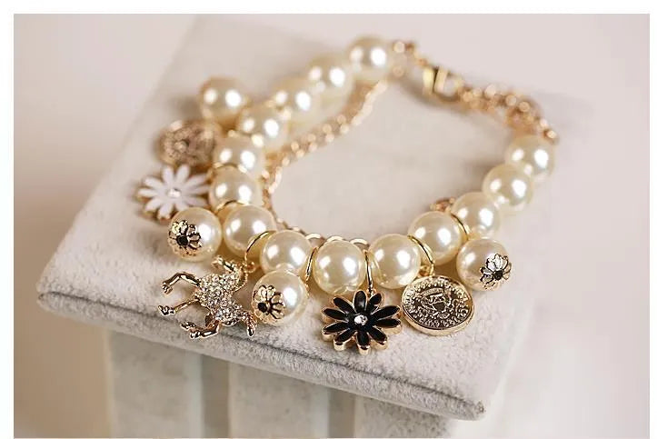 White pearl flower bracelet with simulated pearl beads, floral design, 17cm length, on a soft surface