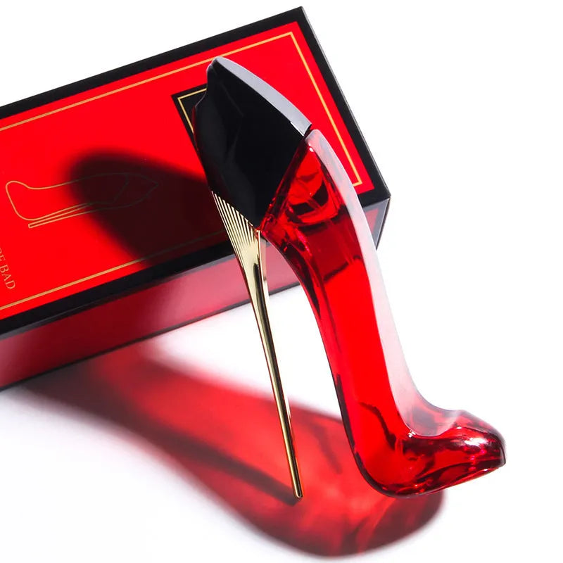 Red high heel shaped 40ml eau de toilette bottle with fruity floral notes including honey, rose and jasmine.
