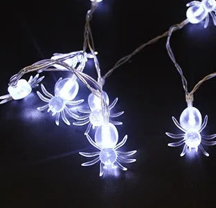 Halloween LED string lights with pumpkin, bat, and ghost decorations hanging on a wall