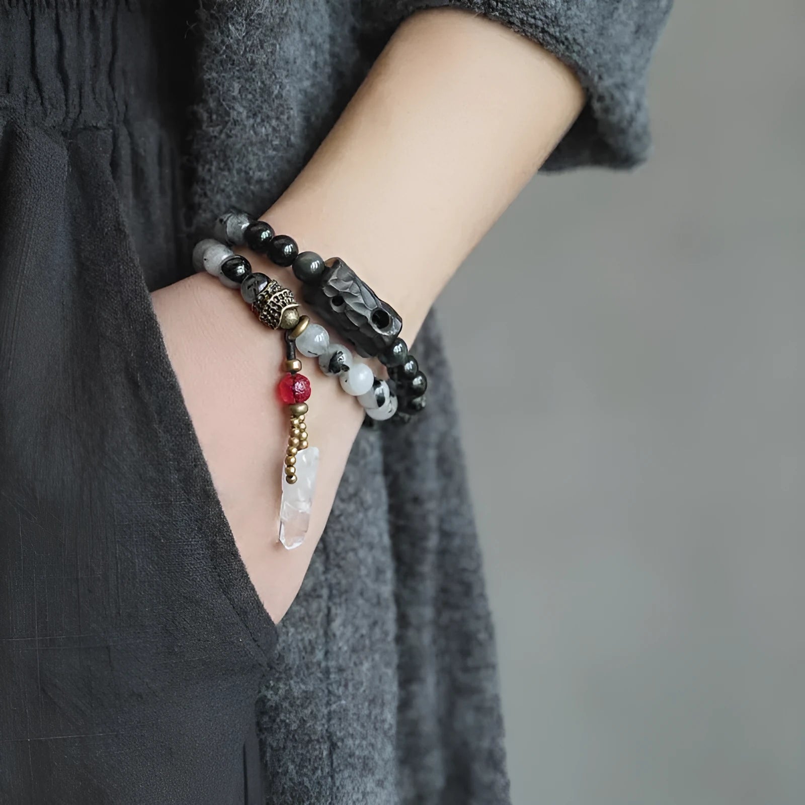 Ethnic black hair bracelet with white crystal tassel, shown in boys and girls size options.