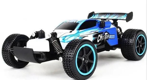Blue 1:18 scale remote control off-road drift car with 2.4Ghz transmitter on a flat surface.