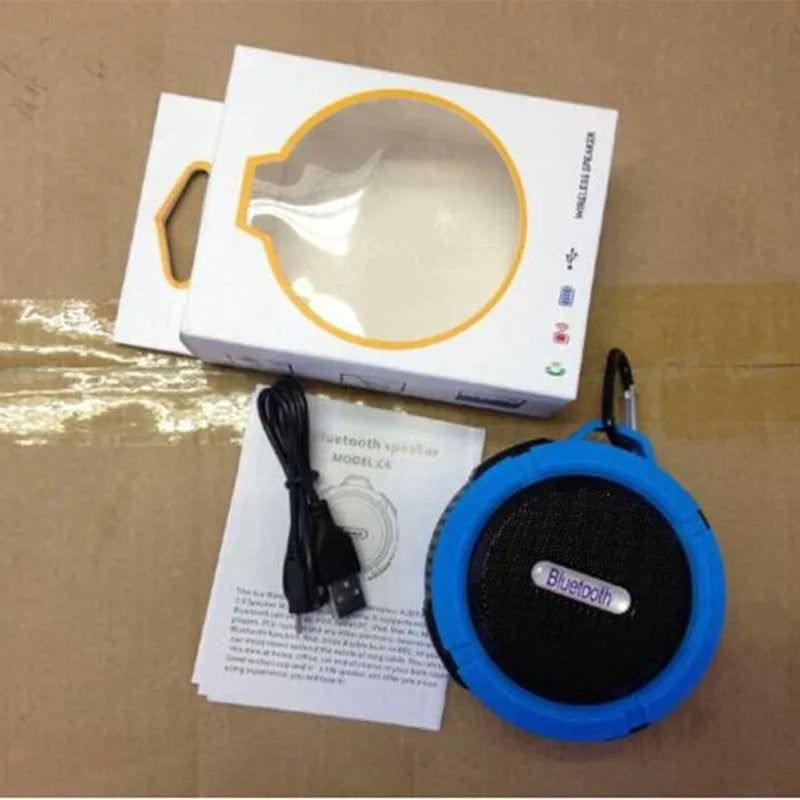 Compact waterproof Bluetooth speaker with a mounting clip, shown in blue.