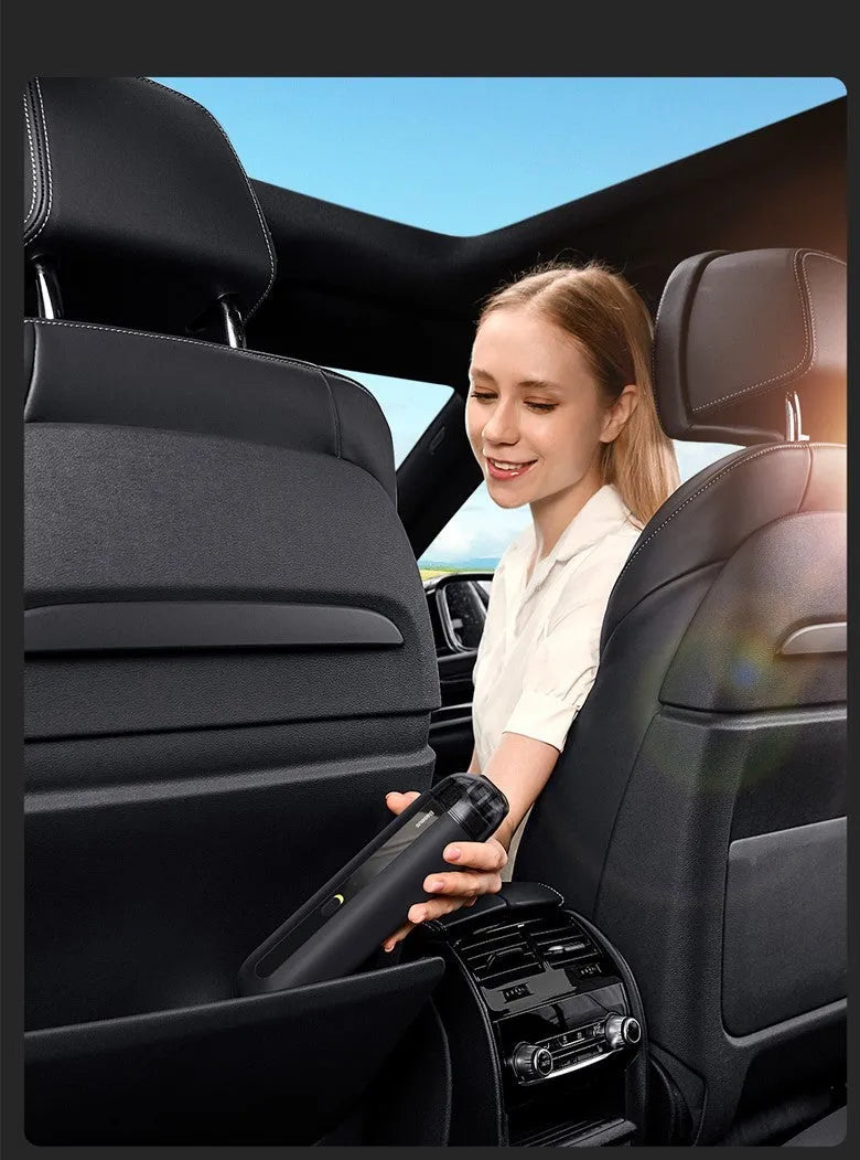 Starry sky black handheld cordless car vacuum cleaner with blowing hose accessory on a desktop.