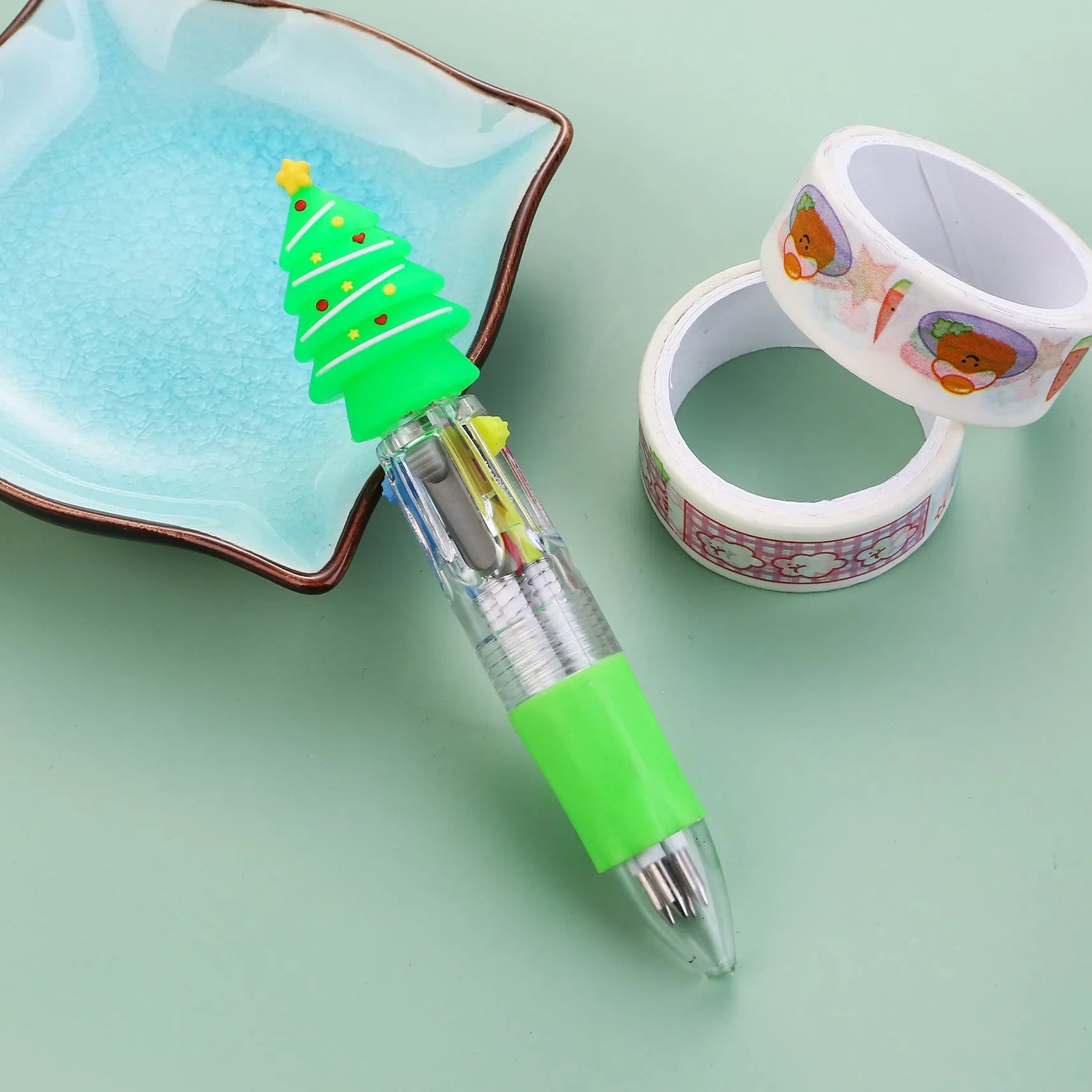 Compact 11cm Christmas ballpoint pen with four colours and festive designs like snowmen and reindeer.