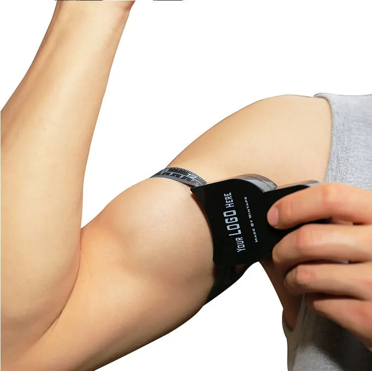 Black ABS plastic body fat caliper for skinfold measurement with a retractable measuring tape.