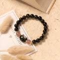 Black natural obsidian bead bracelet with a kitty charm on a stretch cord.