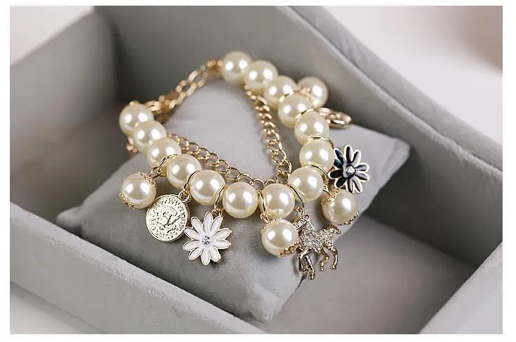 White pearl flower bracelet with simulated pearl beads, floral design, 17cm length, on a soft surface