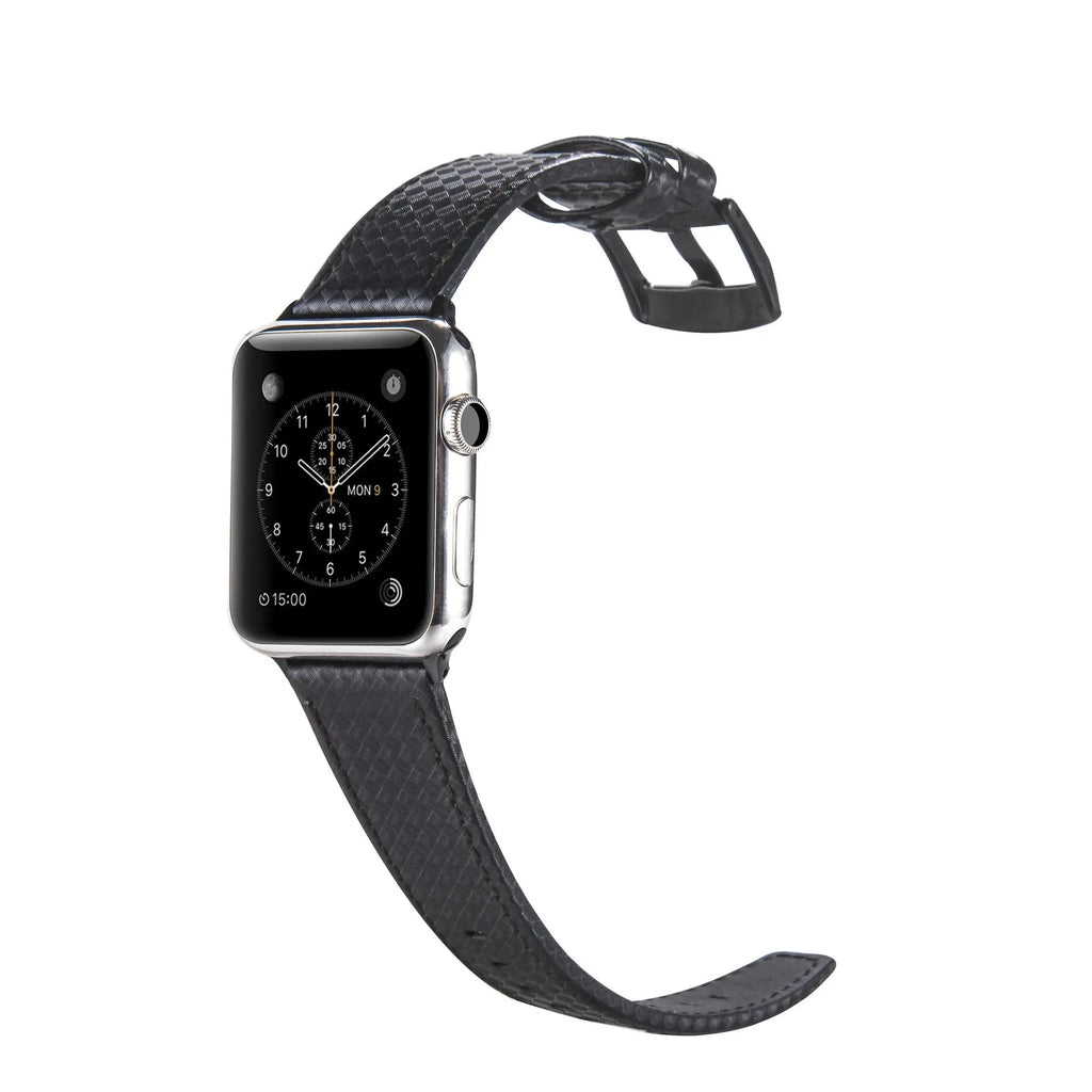 Leather and carbon fibre Apple Watch strap with red stitching next to a black PC case with carbon fibre pattern.
