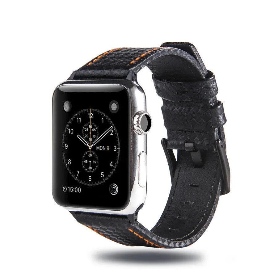 Leather and carbon fibre Apple Watch strap with red stitching next to a black PC case with carbon fibre pattern.