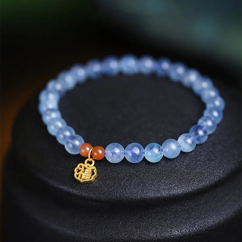 Icy translucent aquamarine crystal bead bracelet with sequin charm and blessing card.