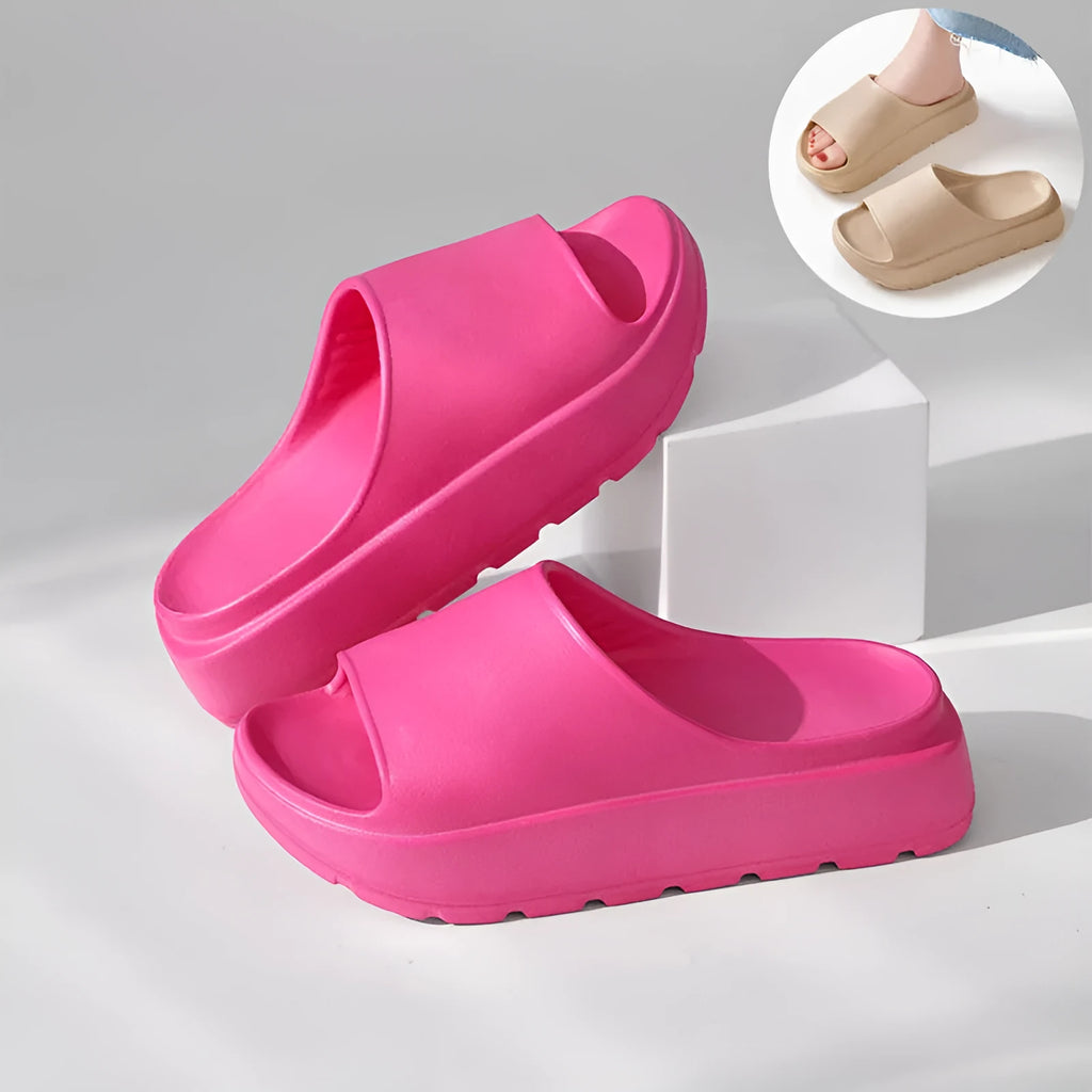 Women's beige fish mouth slippers with a thick EVA sole on a bathroom tile floor.