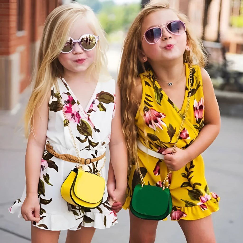 Baby girl wearing a white or yellow floral cotton summer dress.