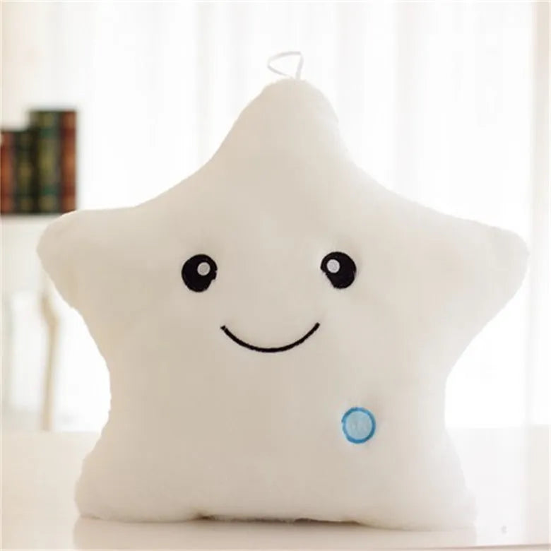 Colourful glowing five-pointed star plush pillow on a dark background, showing soft texture and LED illumination