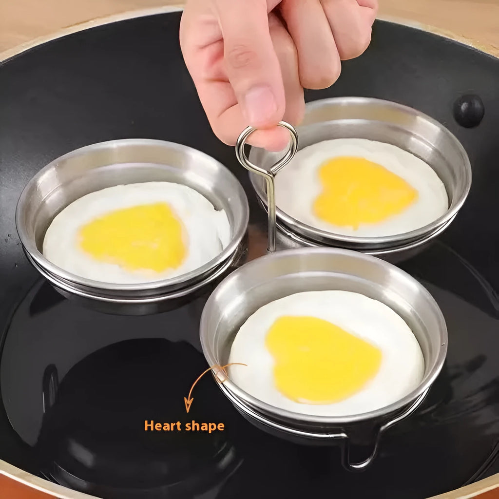 Mini heart-shaped stainless steel egg steamer for cooking a single egg.