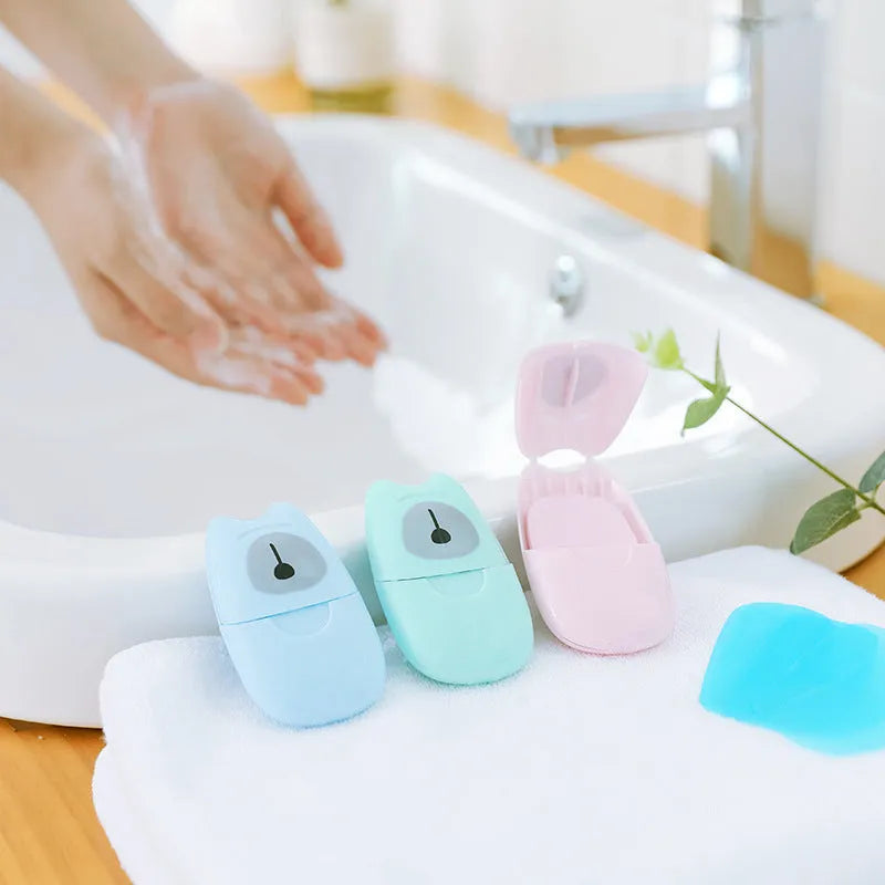 Pack of 50 disposable biodegradable soap paper sheets in pink, blue, and green colours for travel hand cleaning