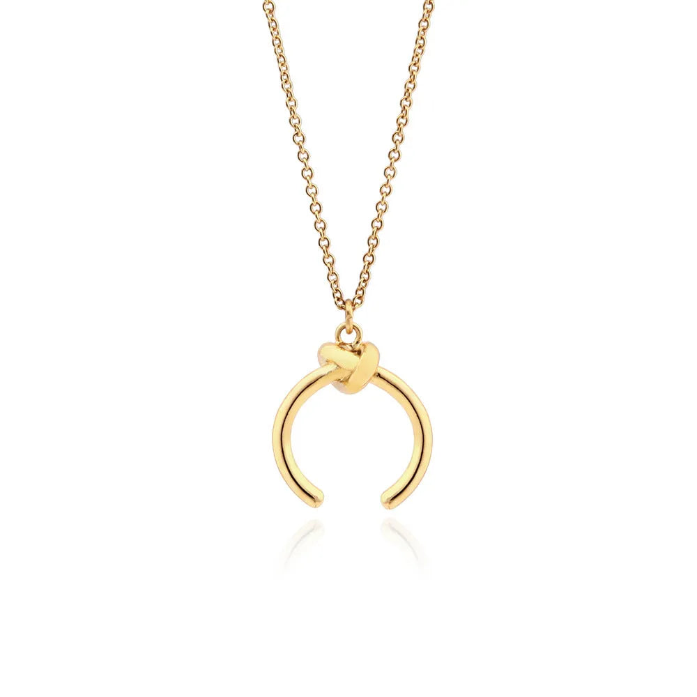 Vintage geometric copper pendant necklace with an adjustable cross chain in a gold finish.