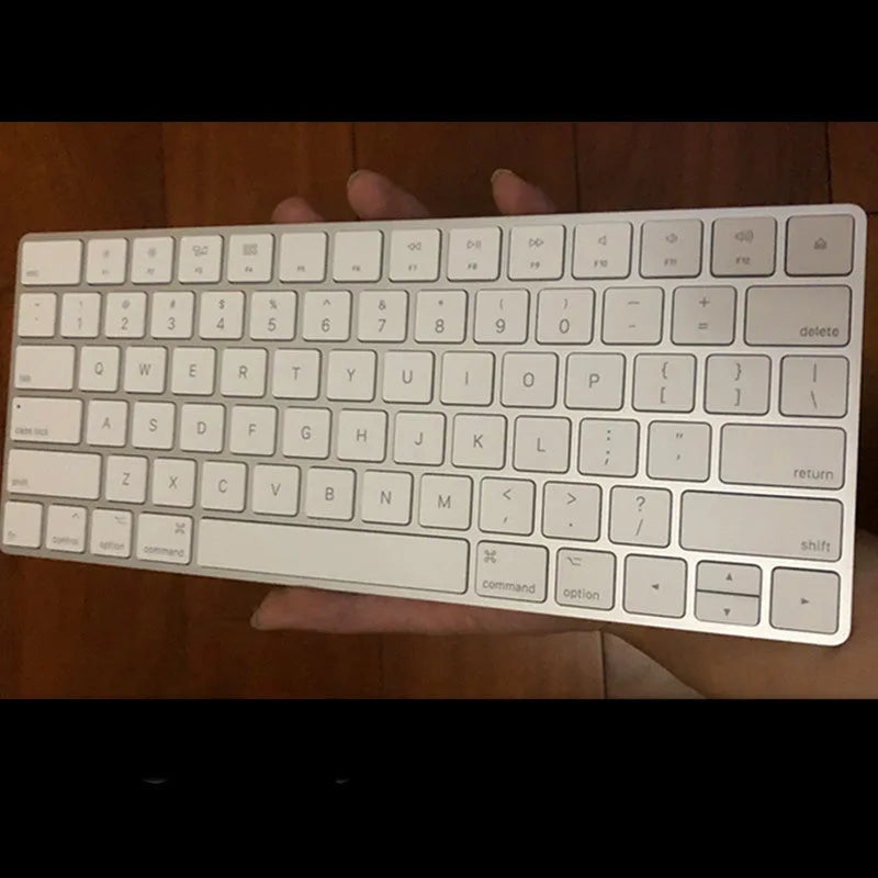White Apple Bluetooth wireless keyboard with ultra-thin metal casing on a desk