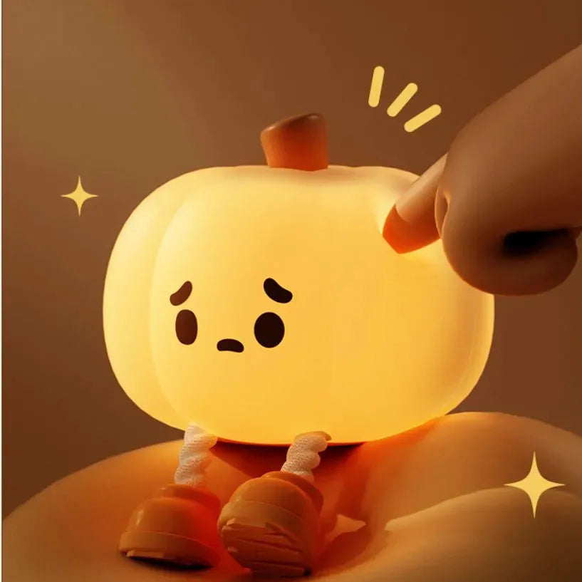 Soft silicone pumpkin-shaped night light with dimmable touch control on bedside table