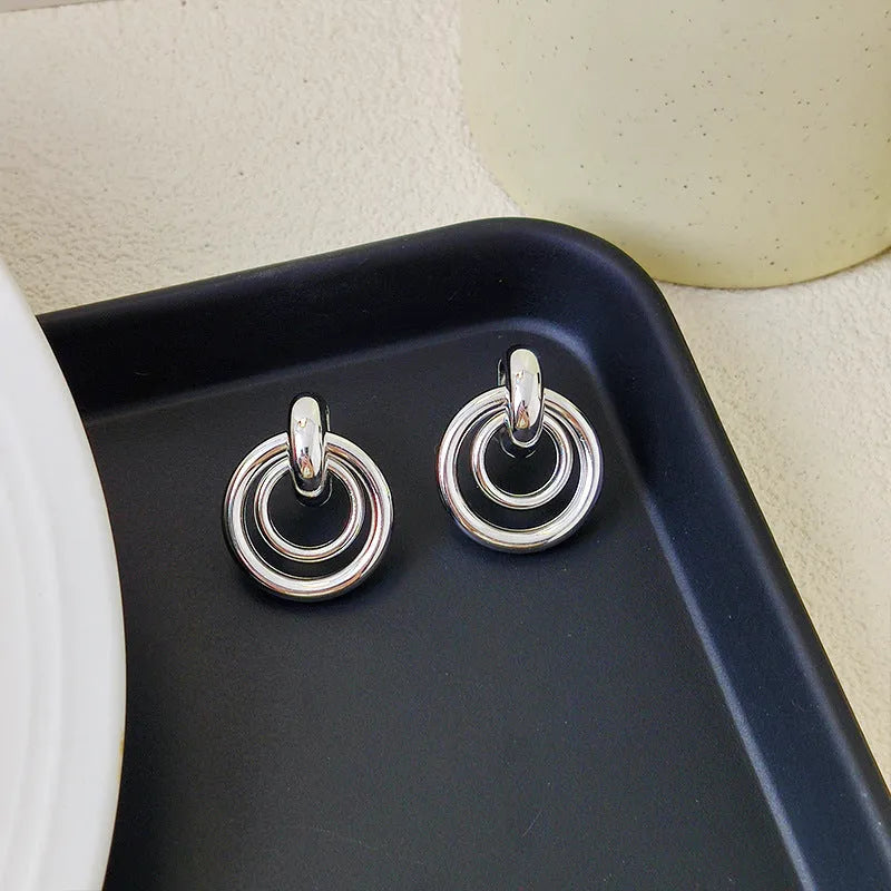 Geometric round ring earrings with irregular styling in gold and silver colour options