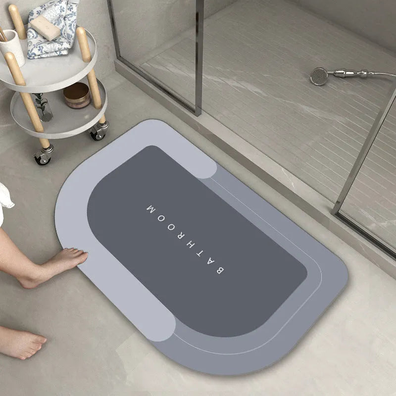 Machine-woven rectangular blue floor mat placed on a bathroom floor.